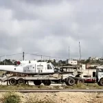 One of the damaged ItalAir helicopters being transported for repair