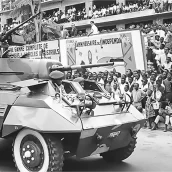 A National Congolese Army (Armée Nationale Congolaise) M8 Staghound armoured car at a parade in the capital Leopoldville, this vehicle has a 12.7mm HMG mounted in the anti-aircraft role
